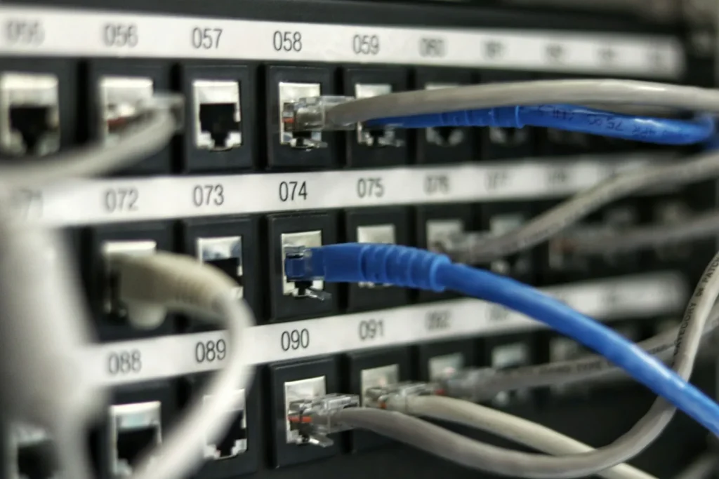 When AI Features Become a Commodity, Cloud Pricing Feels the Heat Engineer walking between server racks in a modern cloud facility