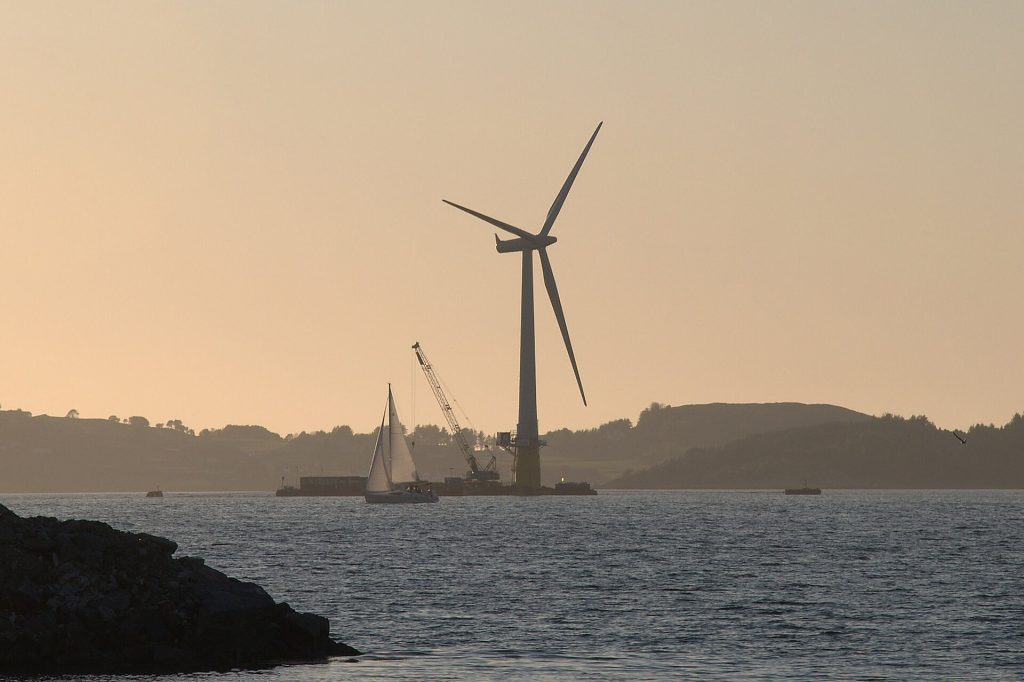 Smart Grids Learn to Flex with the Weather A wind turbine standing in coastal waters