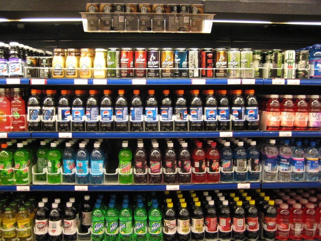 Fresh and packaged foods arranged on a supermarket shelf for comparison